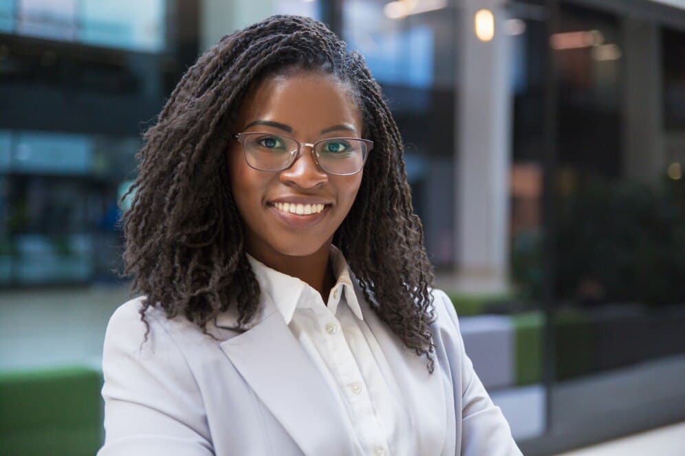 A picture of a woman boldly smiling - How to be a Great HR Leader - BizEdge Post