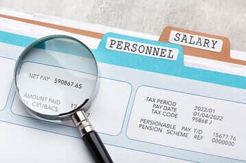 a lens highlighting net pay on a file - salary review - BizEdge blog
