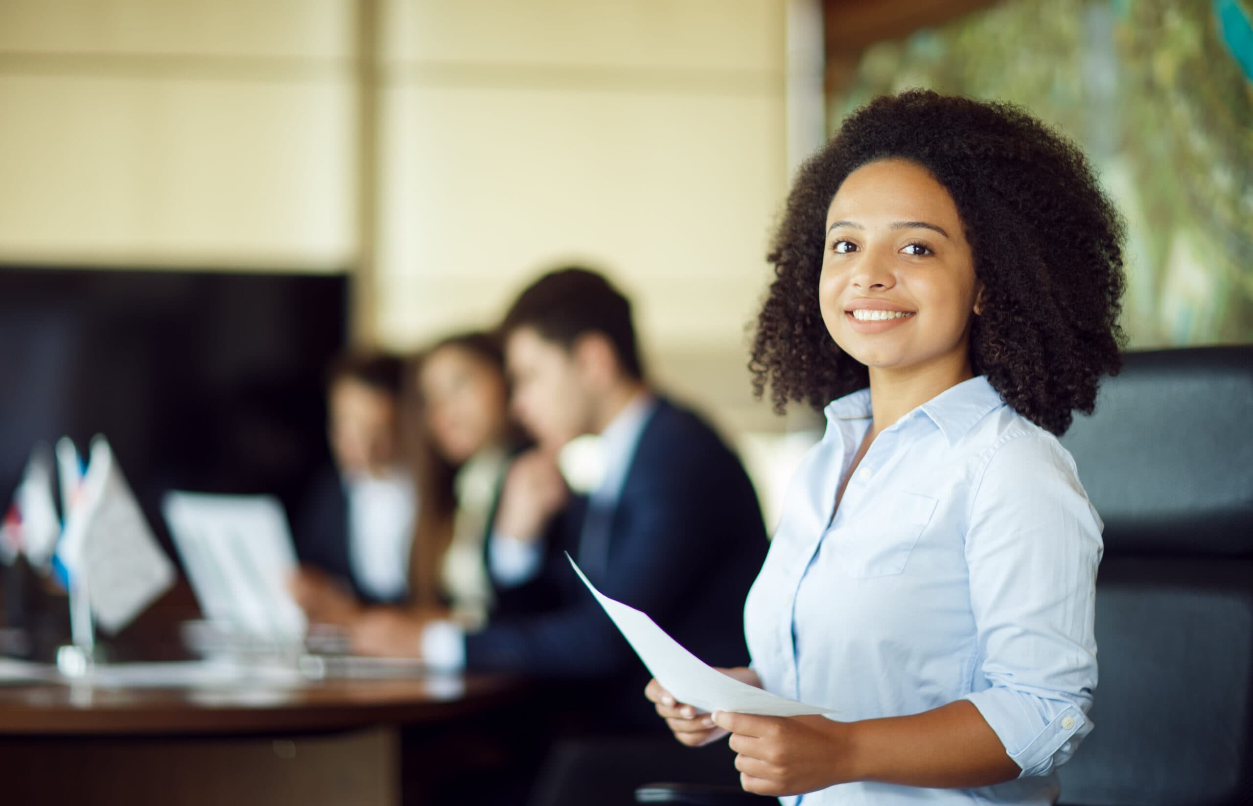 A picture of a lady smiling - BizEdge Blog - How to Reduce Attrition Rate at the Workplace