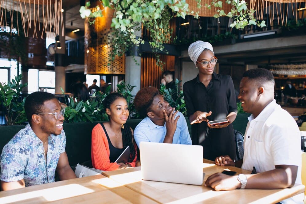 A picture of a group of people working together - Why Your Business Needs a 360 Performance Management System - BizEdge blog