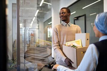 a man holding different document in a carton -employee turnover - BizEdge blog