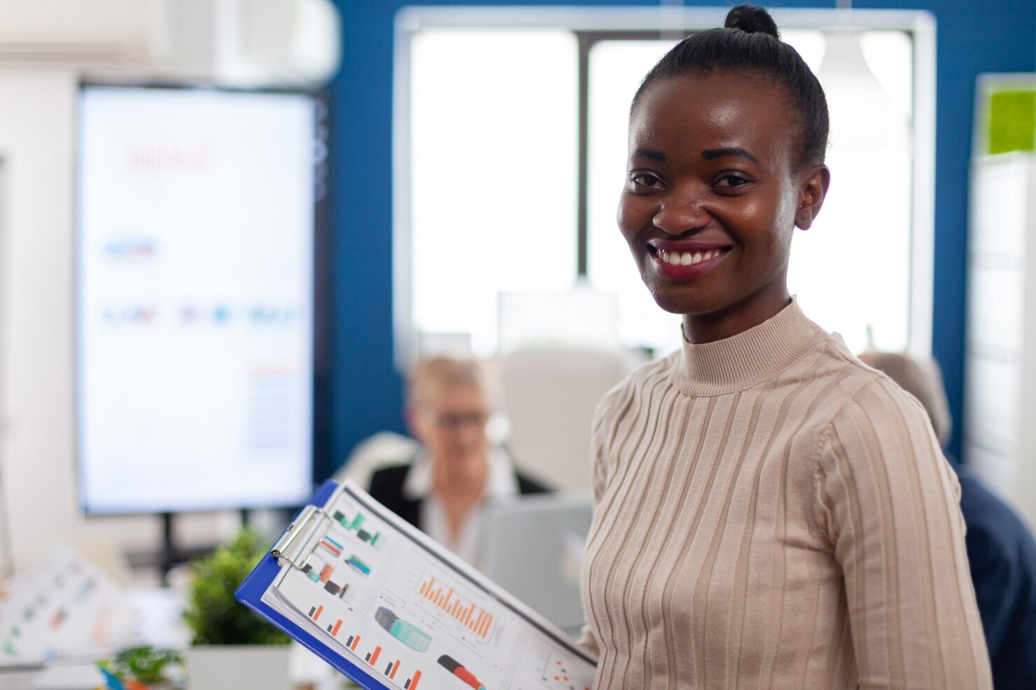 A smiling employee. Implementing a 360 feedback in your organisation performance review. Best way to review your employees performance.