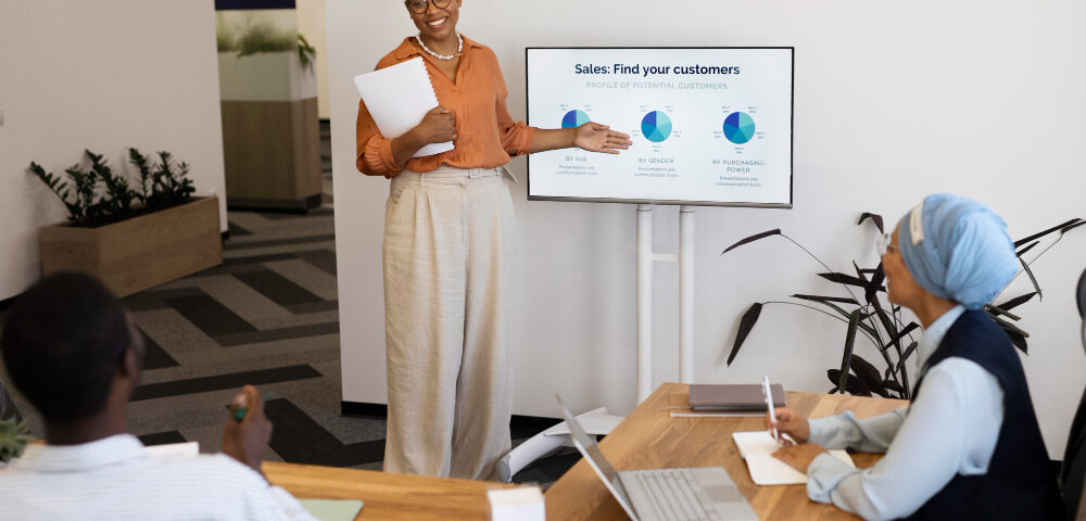 A picture of a lady lecturing a set of people on sales - Employee Training Program - BizEdge post