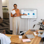 A picture of a lady lecturing a set of people on sales - Employee Training Program - BizEdge post