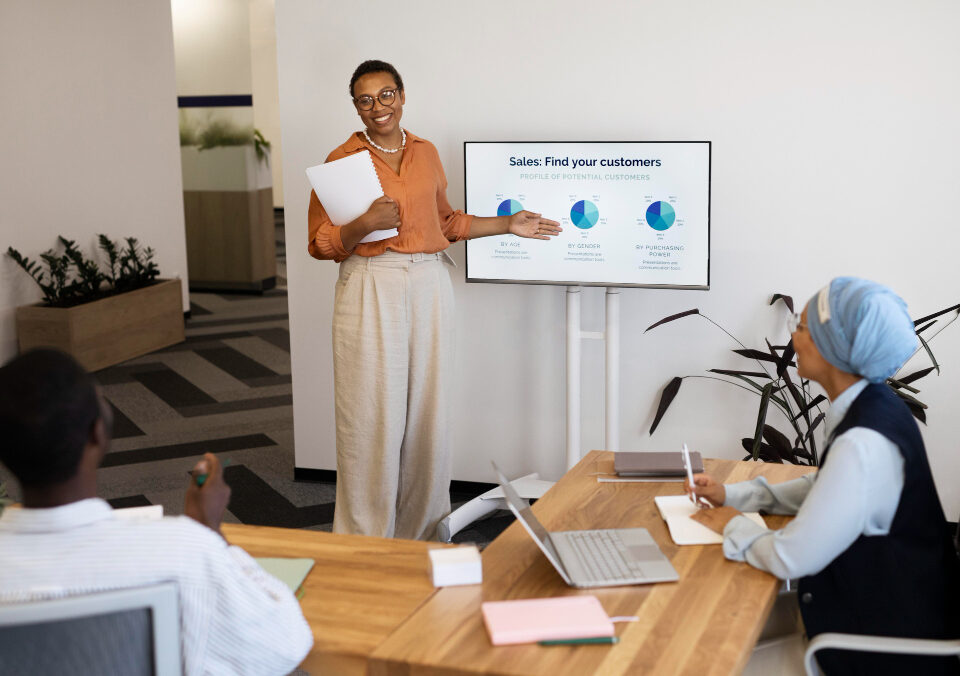 A picture of a lady lecturing a set of people on sales - Employee Training Program - BizEdge post