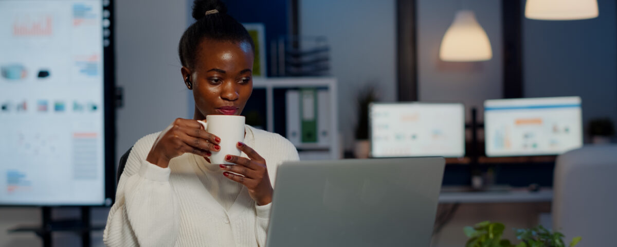 A picture of a woman drinking a coffee during a virtual meeting with team members - How to Boost Productivity with Employee Self-Service Portal - BizEdge post