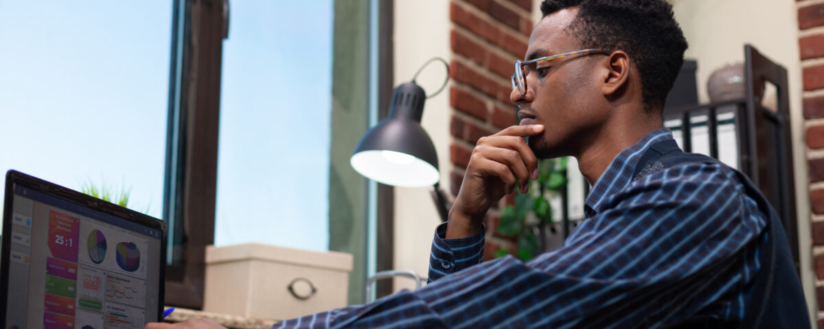 A man focused on his laptop screen - Is the Four-Day Workweek the Future or Just a Trend? - BizEdge blog