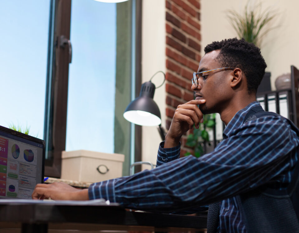 A man focused on his laptop screen - Is the Four-Day Workweek the Future or Just a Trend? - BizEdge blog