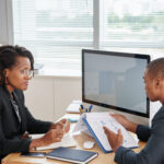 Two colleagues discussing - Why HR Should Prioritize Culture Fit When Hiring - BizEdge blog