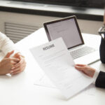 A company representative reading an applicant resume- reference check - BizEdge blog