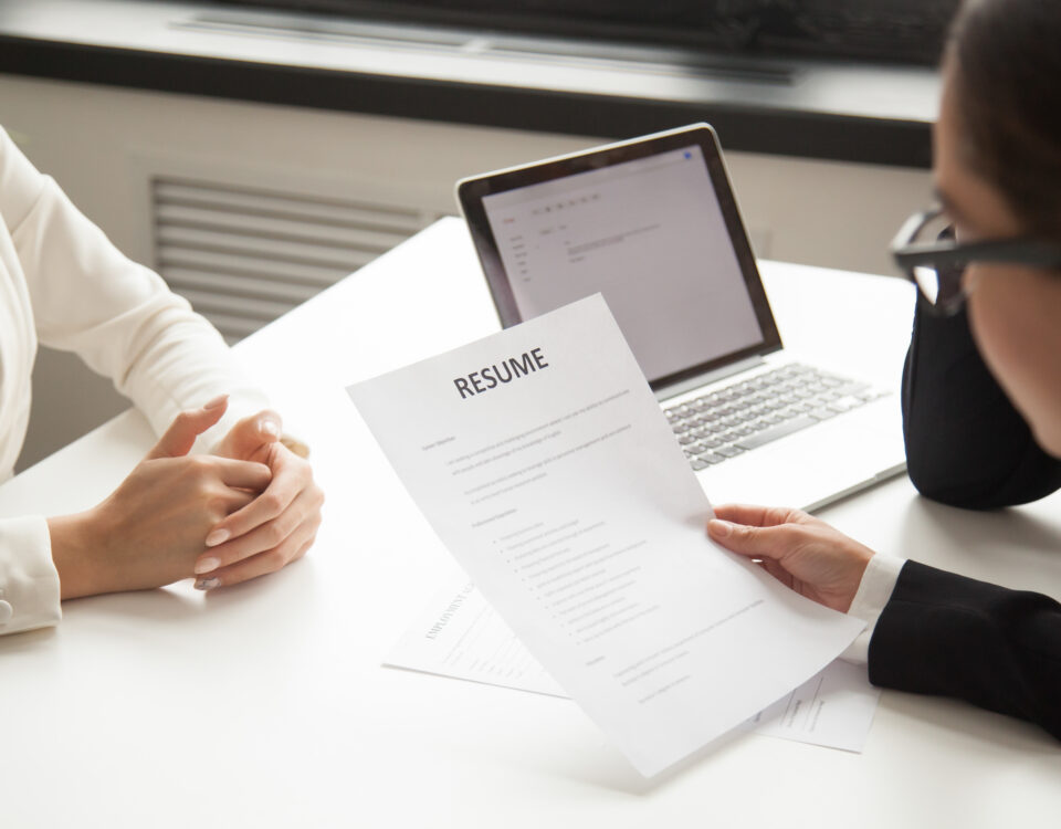 A company representative reading an applicant resume- reference check - BizEdge blog