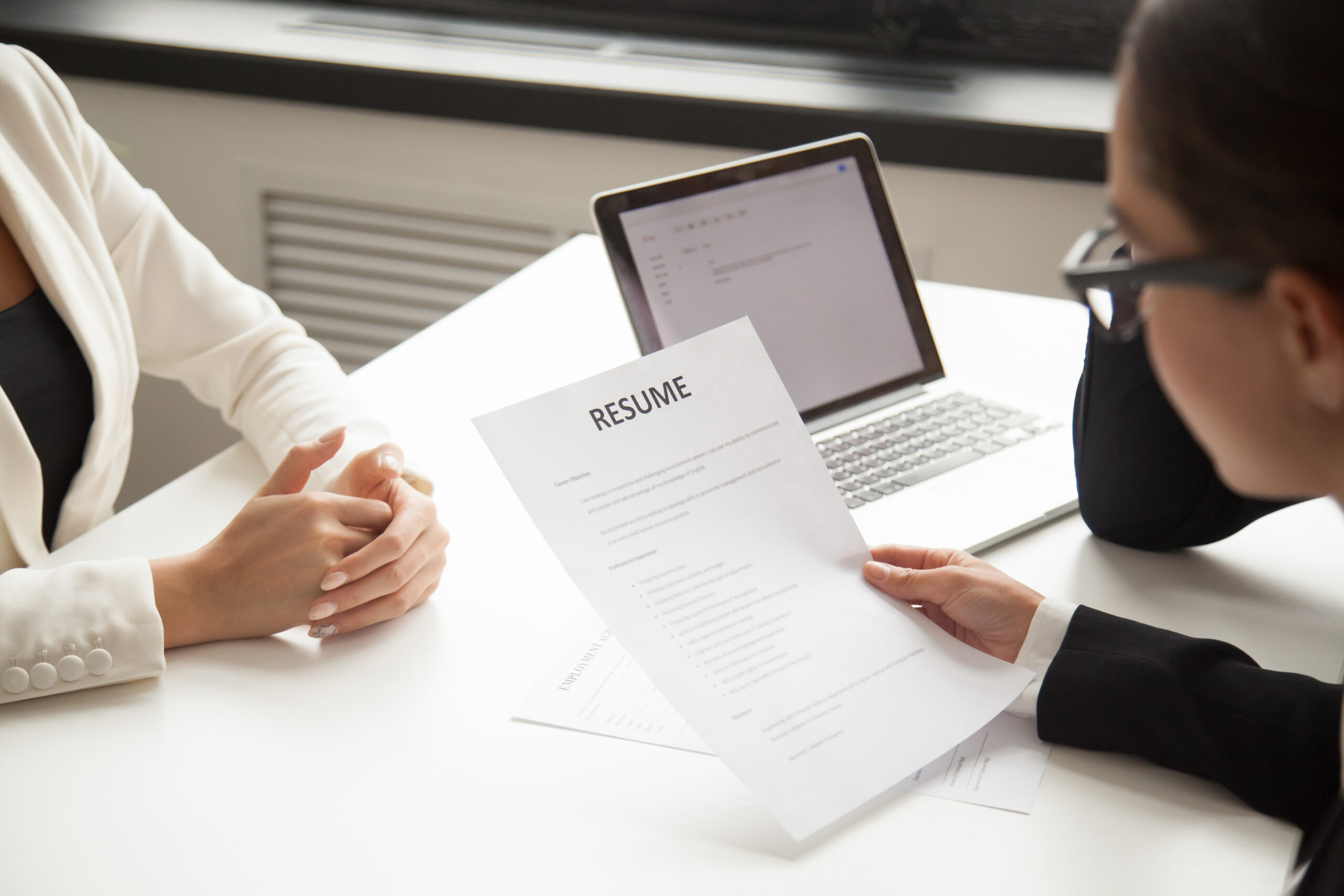 A company representative reading an applicant resume- reference check - BizEdge blog
