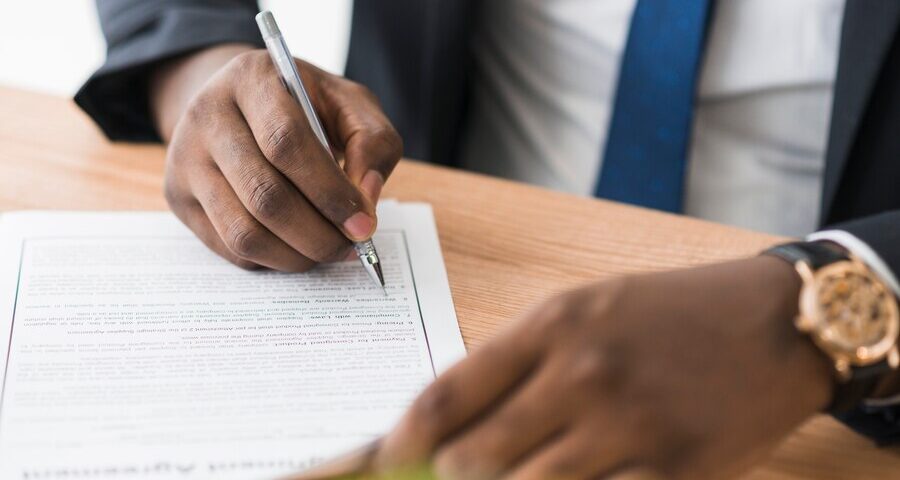 A picture of a man confirming a document - Employeme verification vs. Reference Check - BizEdge post