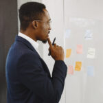 A picture of a man strategizing - Why Your Retention Strategy Needs a Mid-Level Focus - BizEdge Blog
