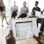 A picture of a calendar on someone's hand - Why Employee Time Tracking is Important - BizEdge blog