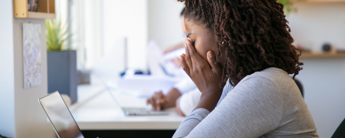 A picture of an exhausted employee working on project in office - Causes of Employee Burnout – Poor Rota Planning (Part 1) - BizEdge blog