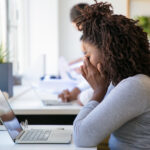 A picture of an exhausted employee working on project in office - Causes of Employee Burnout – Poor Rota Planning (Part 1) - BizEdge blog