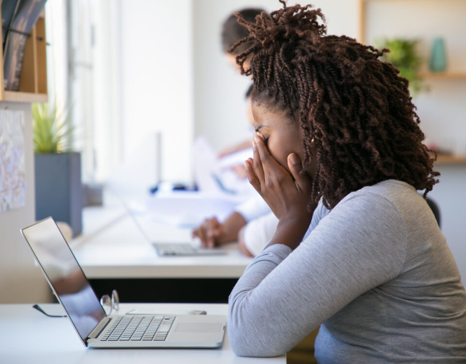 A picture of an exhausted employee working on project in office - Causes of Employee Burnout – Poor Rota Planning (Part 1) - BizEdge blog