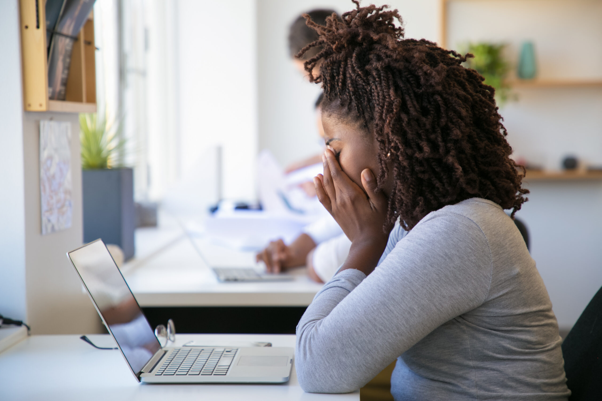 A picture of an exhausted employee working on project in office - Causes of Employee Burnout – Poor Rota Planning (Part 1) - BizEdge blog