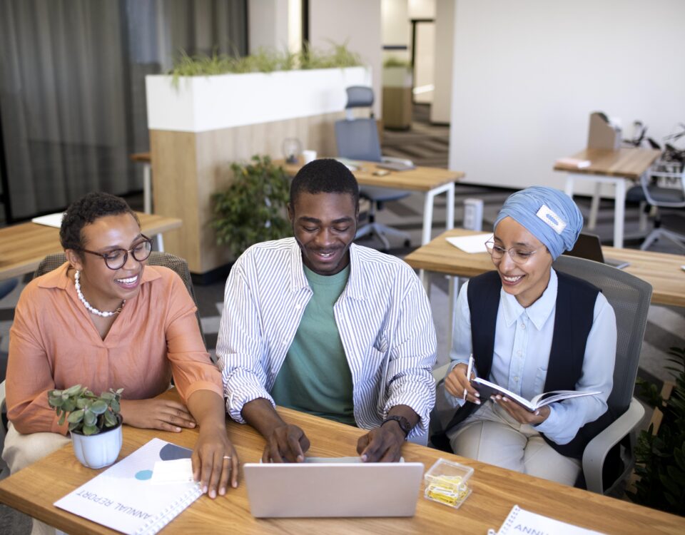 A group of people collaborating in the office - How to Create a Workplace Culture That Retains Top Talent- BizEdge blog
