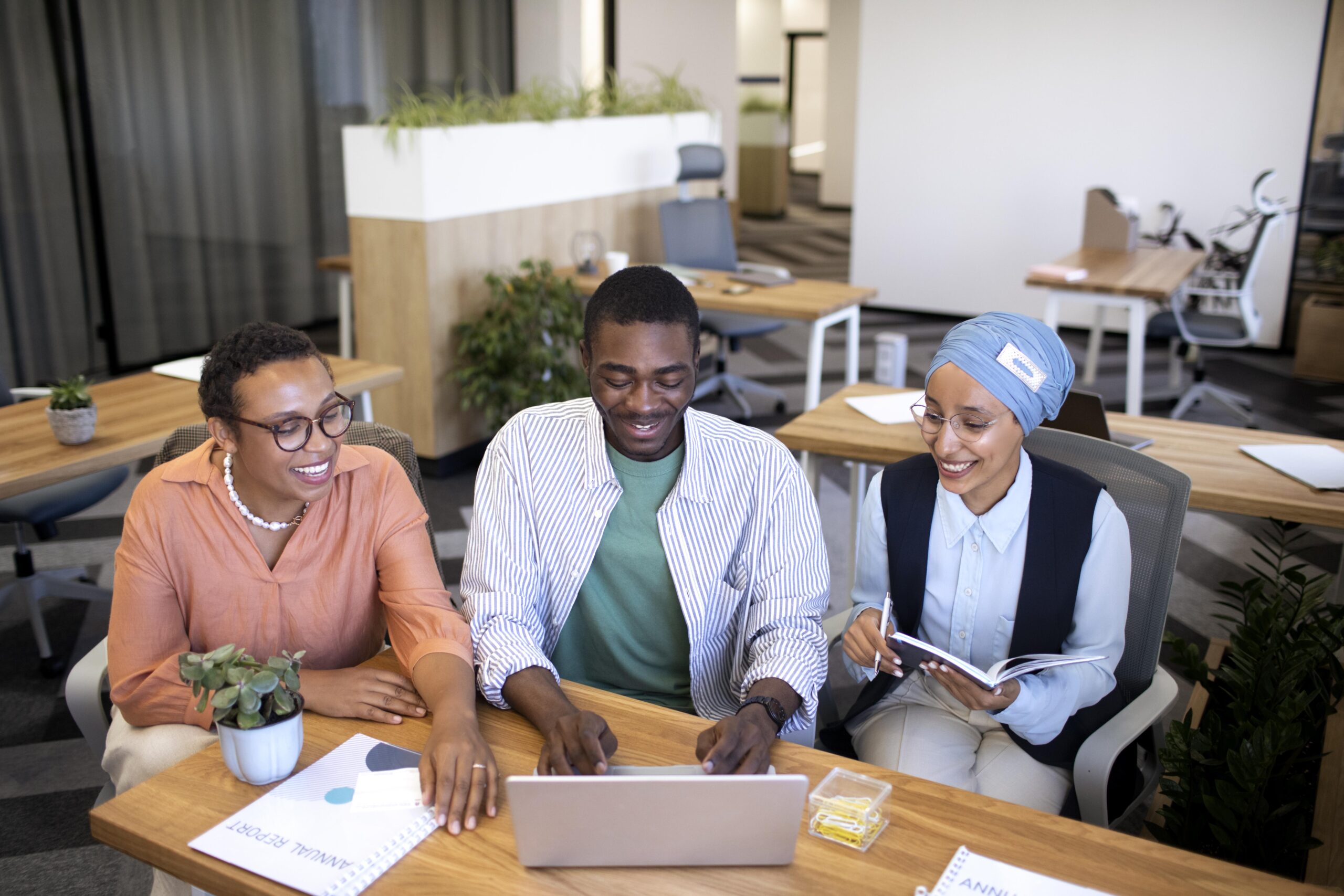 A group of people collaborating in the office - How to Create a Workplace Culture That Retains Top Talent- BizEdge blog