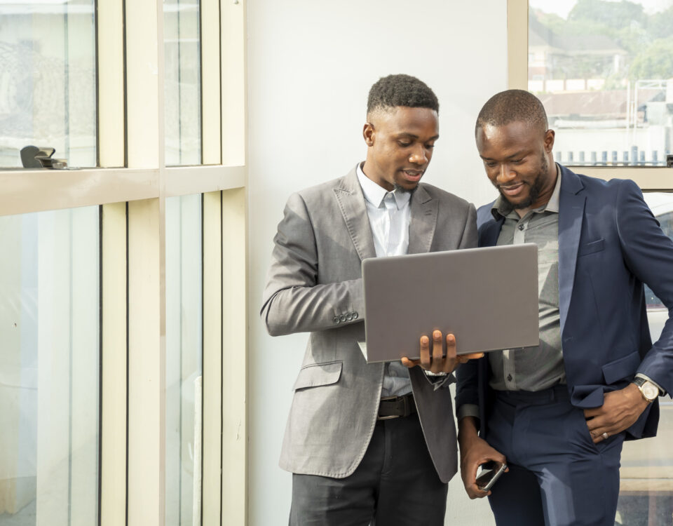Two men viewing something on laptop - Tax Health Report -BizEdge blog