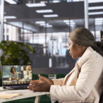 A woman on a video call on her system - why digital transformation in hr is important - BizEdge blog
