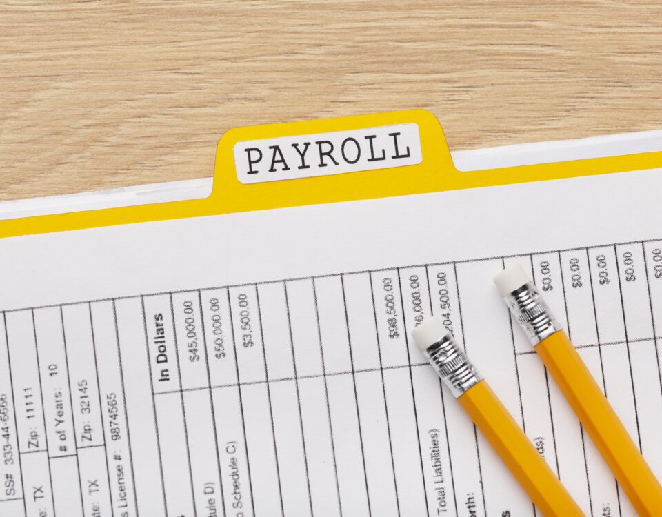 a picture of a payslip with a pen - payroll reconciliation - BizEdge blog