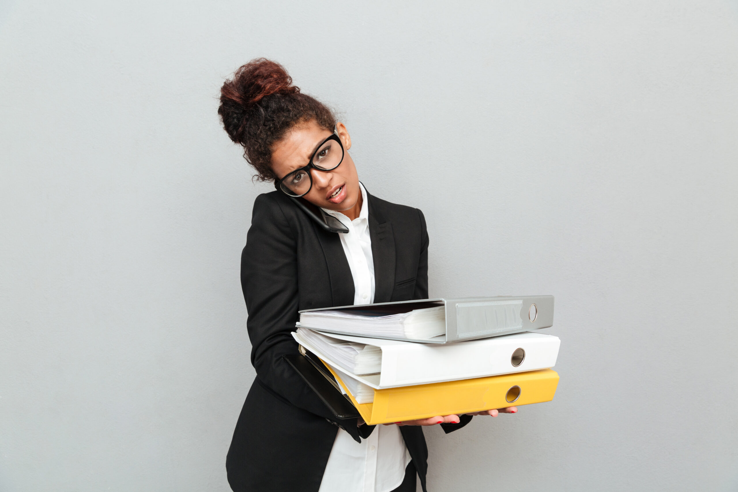 a woman carrying a set of files on her hand - Manual HR processes - BizEdge blog