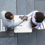 A picture of two people discussing - How to Conduct Stay Interviews - BizEdge blog
