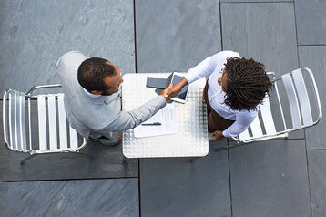 A picture of two people discussing - How to Conduct Stay Interviews - BizEdge blog