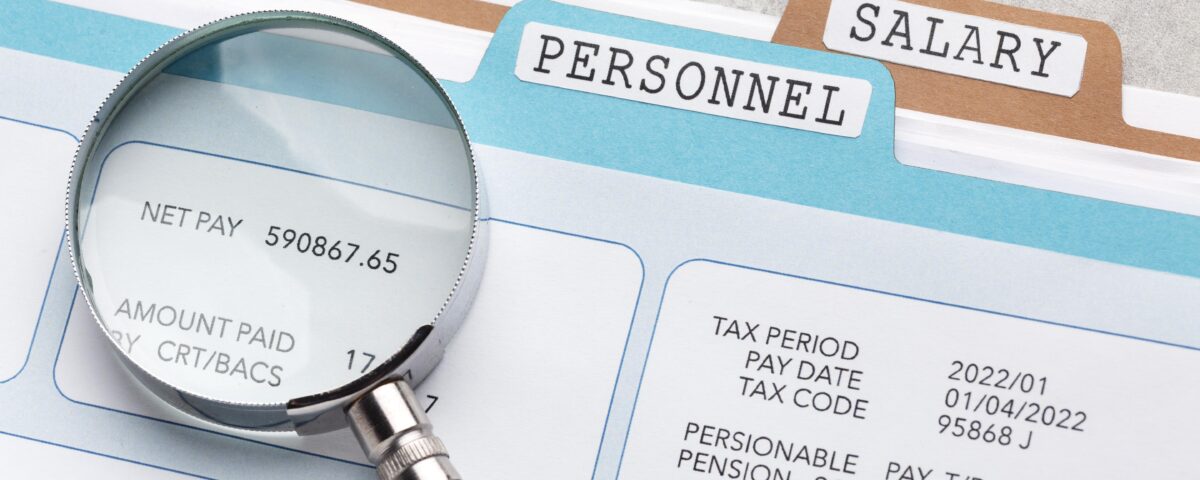 a lens highlighting net pay on a file - salary review - BizEdge blog