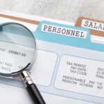 a lens highlighting net pay on a file - salary review - BizEdge blog
