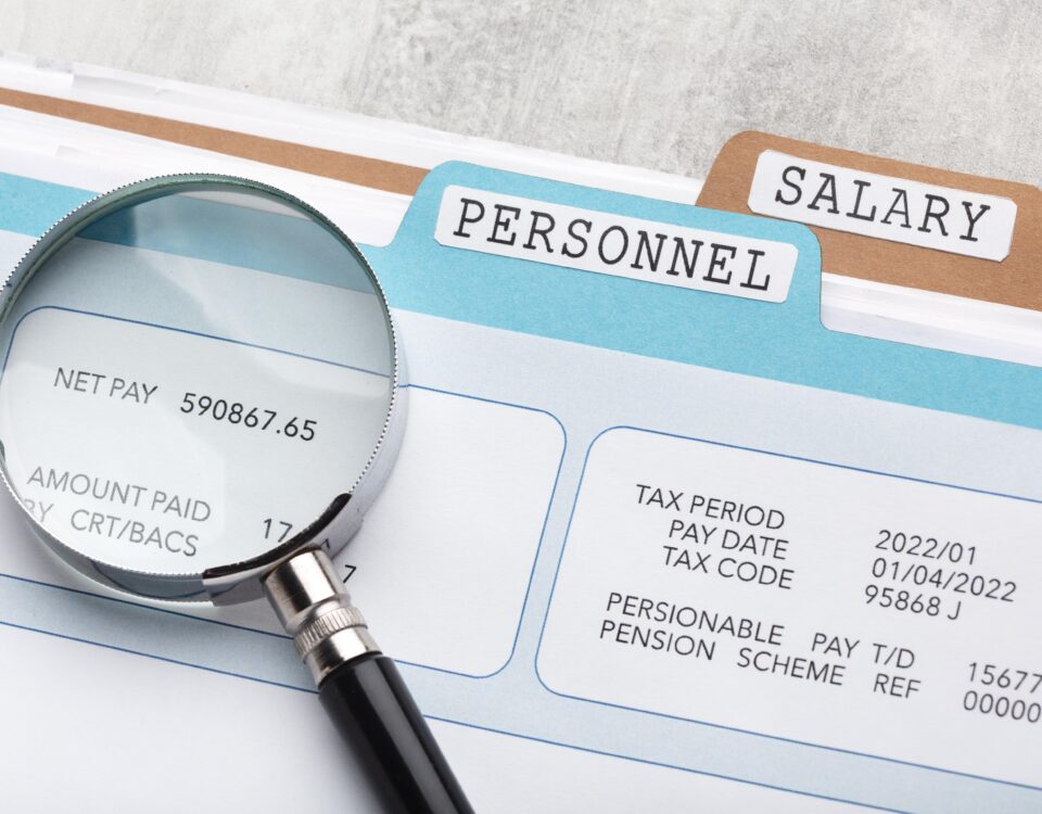 a lens highlighting net pay on a file - salary review - BizEdge blog