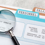 a lens highlighting net pay on a file - salary review - BizEdge blog