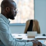 company employee standing in his office space while using his tablet - BizEdge v2 - BizEdge blog