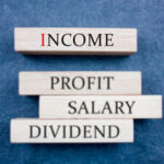 a jenga stick wood that has the word income, profit, salary and dividend written on it - salary structure - BizEdge blog