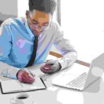 a man working on his laptop - Payroll Automation - BizEdge blog