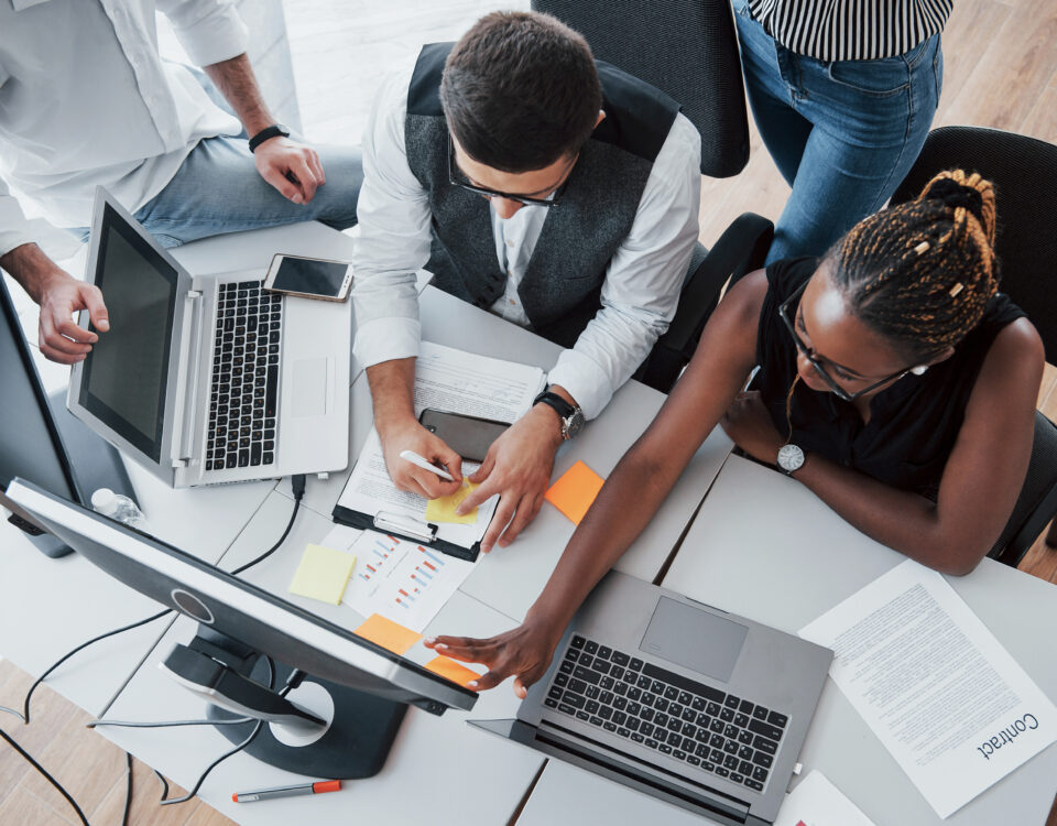 group of people working on the same desk - build future ready teams - BizEdge blog