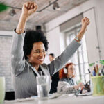 her system excited with her arms raised - 13th month salary - BizEdge blog