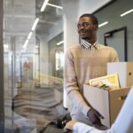 a man holding different document in a carton -employee turnover - BizEdge blog