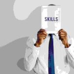 a man holding a pamphlet saying skills written on it - skills gap - BizEdge blog