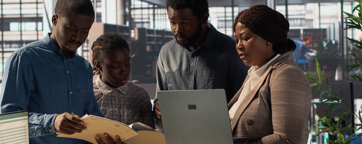 Staff members and leader analyzing a report - employee engagement tips - BizEdge blog