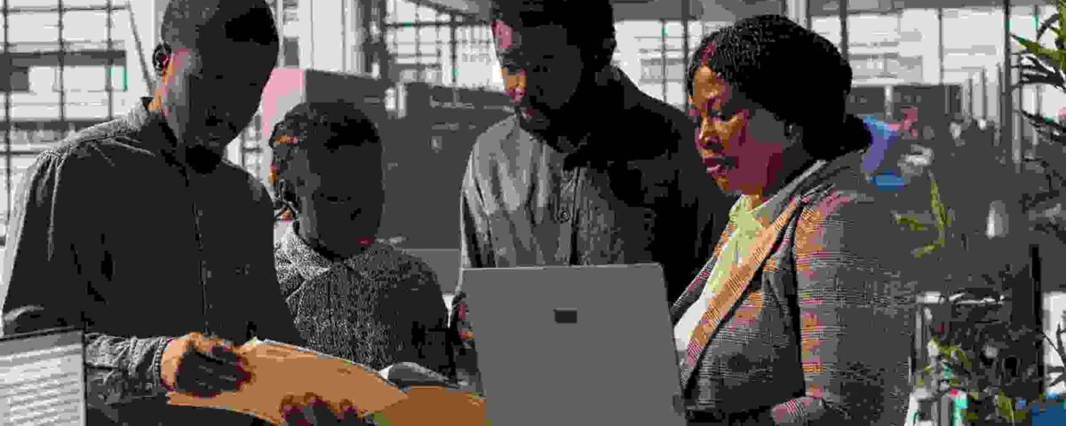 Staff members and leader analyzing a report - employee engagement tips - BizEdge blog