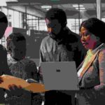 Staff members and leader analyzing a report - employee engagement tips - BizEdge blog