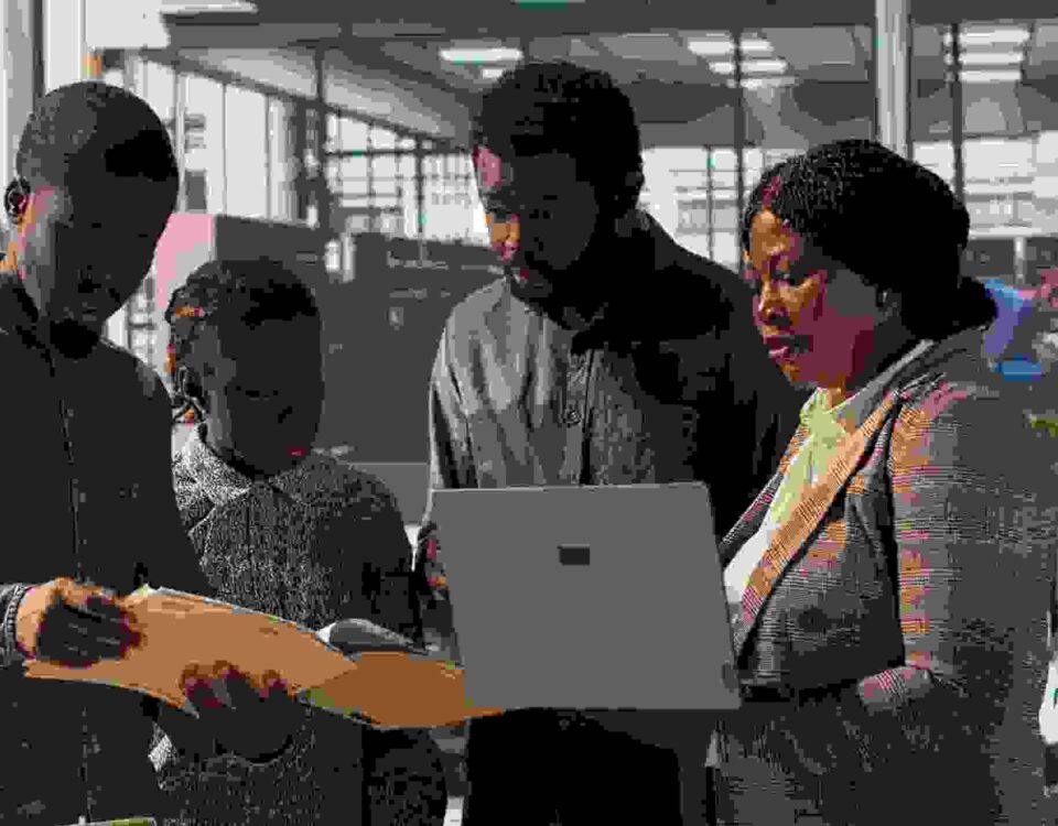 Staff members and leader analyzing a report - employee engagement tips - BizEdge blog