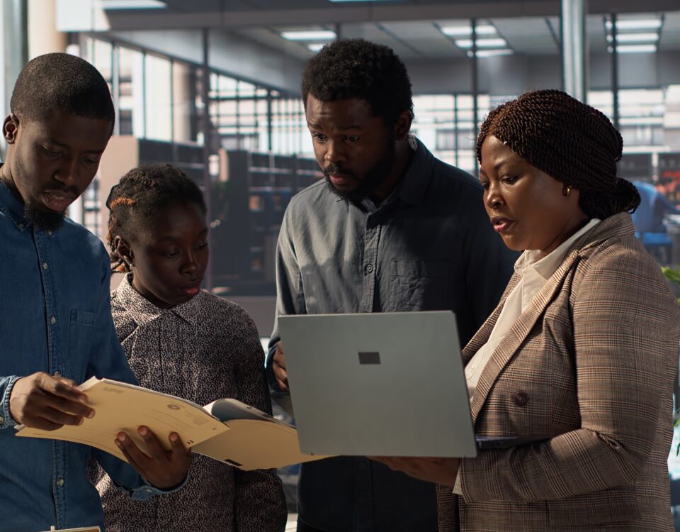 Staff members and leader analyzing a report - employee engagement tips - BizEdge blog