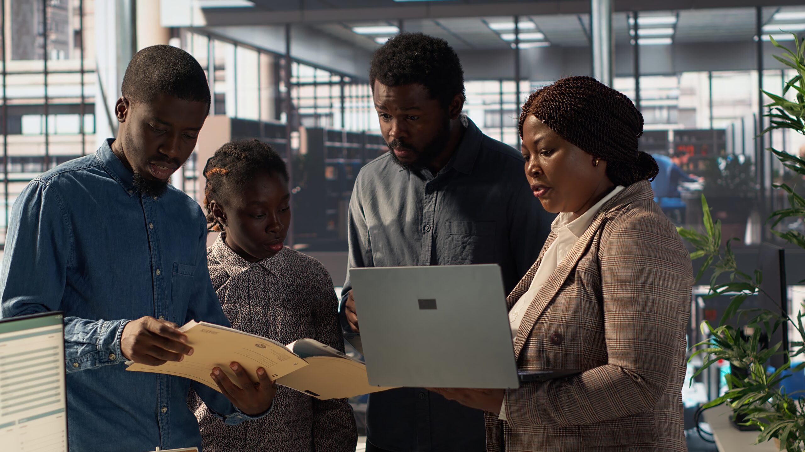 Staff members and leader analyzing a report - employee engagement tips - BizEdge blog