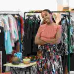 a woman smiling in her clothing brand shop - new nigeria tax act 2025 - BizEdge blog