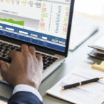 a man using his computer at his desk - HR - BizEdge blog